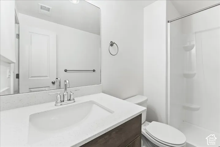Full bath featuring vanity and a stall shower