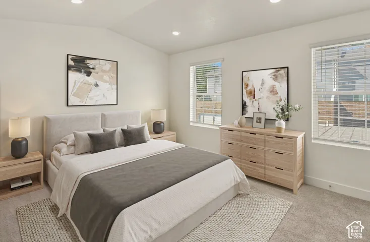 Vaulted ceiling with recessed lighting, two windows with blinds, light-toned carpeting, and neutral wall tones