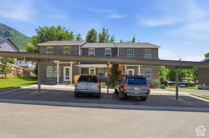 Brick and siding exterior with white window trim
