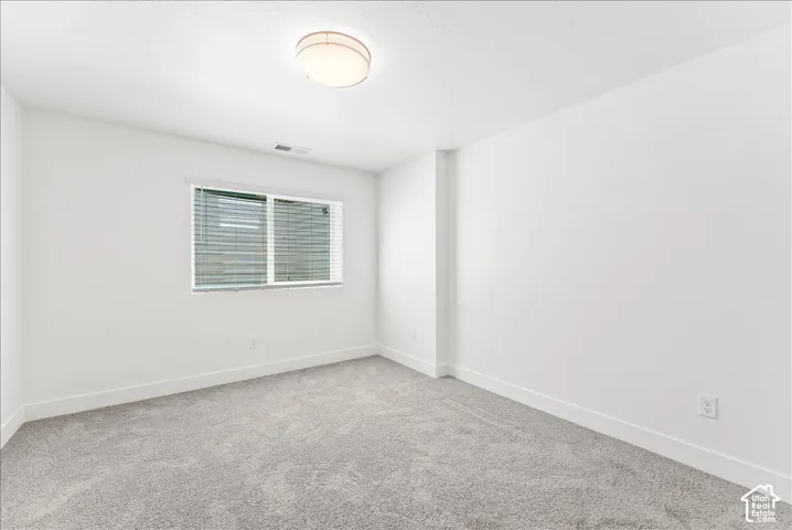 Unfurnished room with baseboards and carpet floors