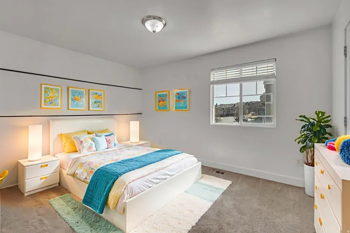 Bedroom featuring light colored carpet and baseboards