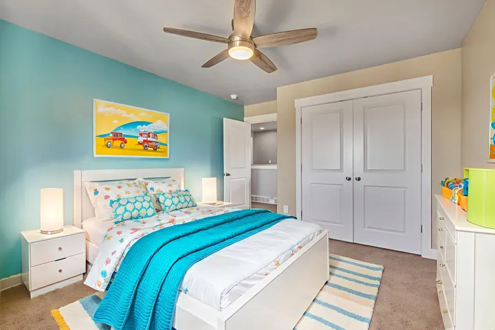 Bedroom featuring light carpet, a ceiling fan, and a closet