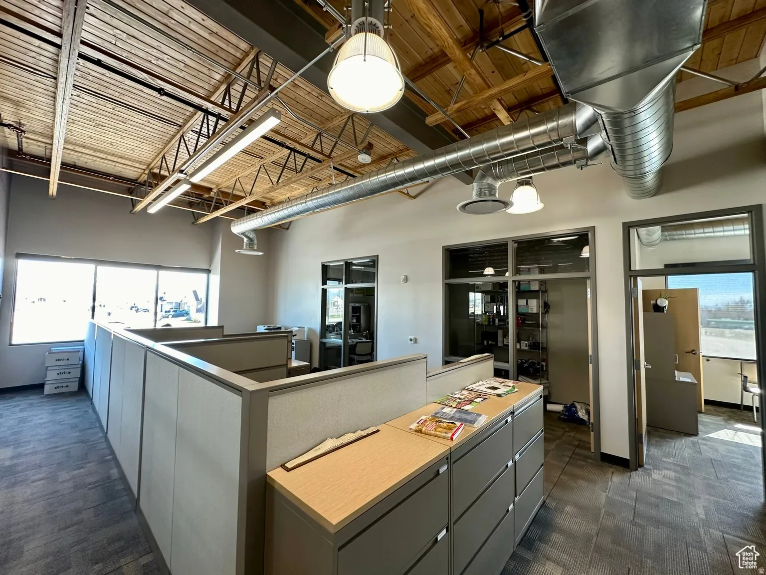 Kitchen featuring a high ceiling, a kitchen island, and gray cabinets
