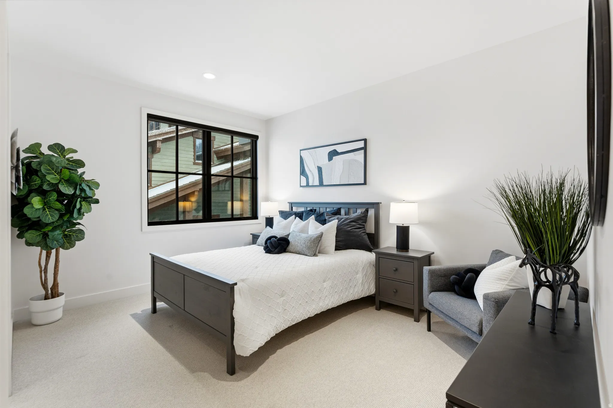 Bedroom with light carpet and baseboards
