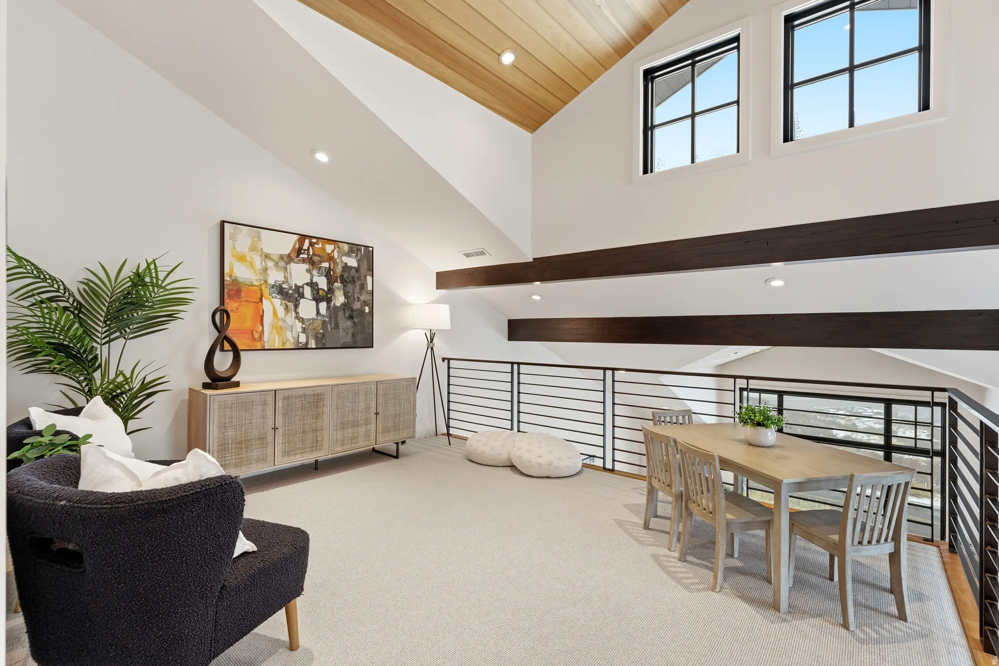 Living area with recessed lighting, vaulted ceiling, light colored carpet, and healthy amount of natural light