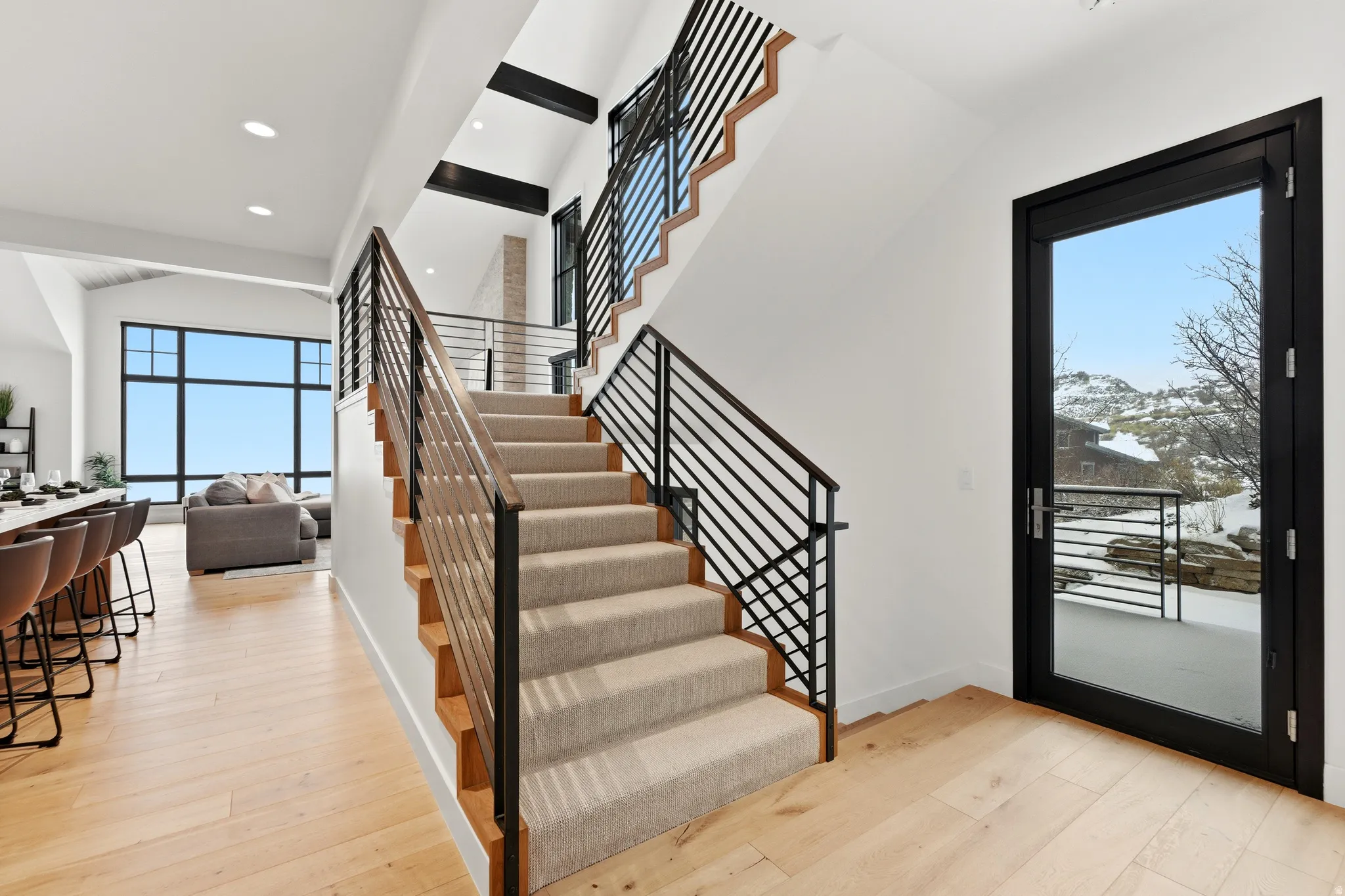 Foyer entrance with light wood-type flooring, a high ceiling, and recessed lighting