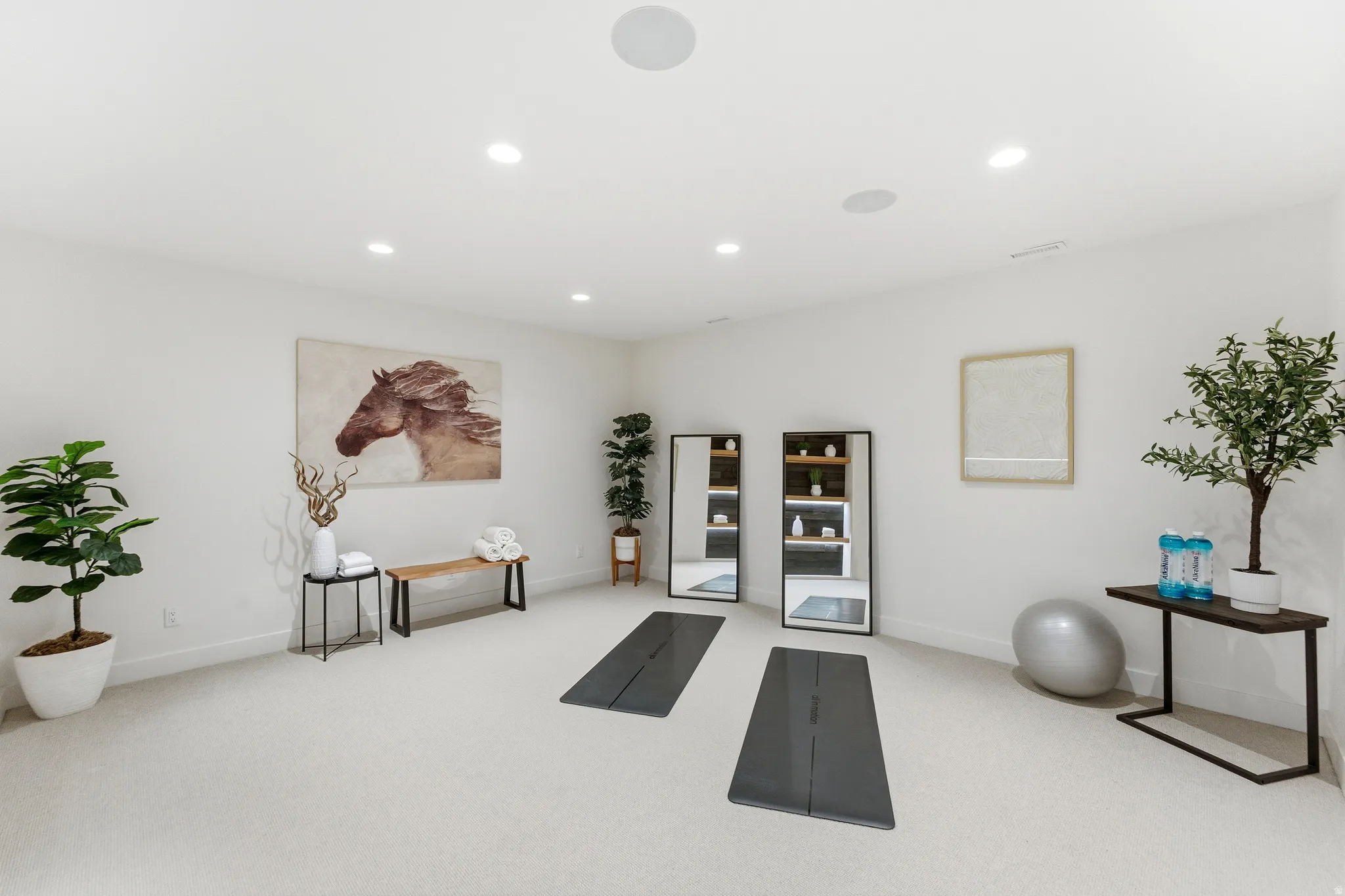 Exercise room with light carpet and recessed lighting
