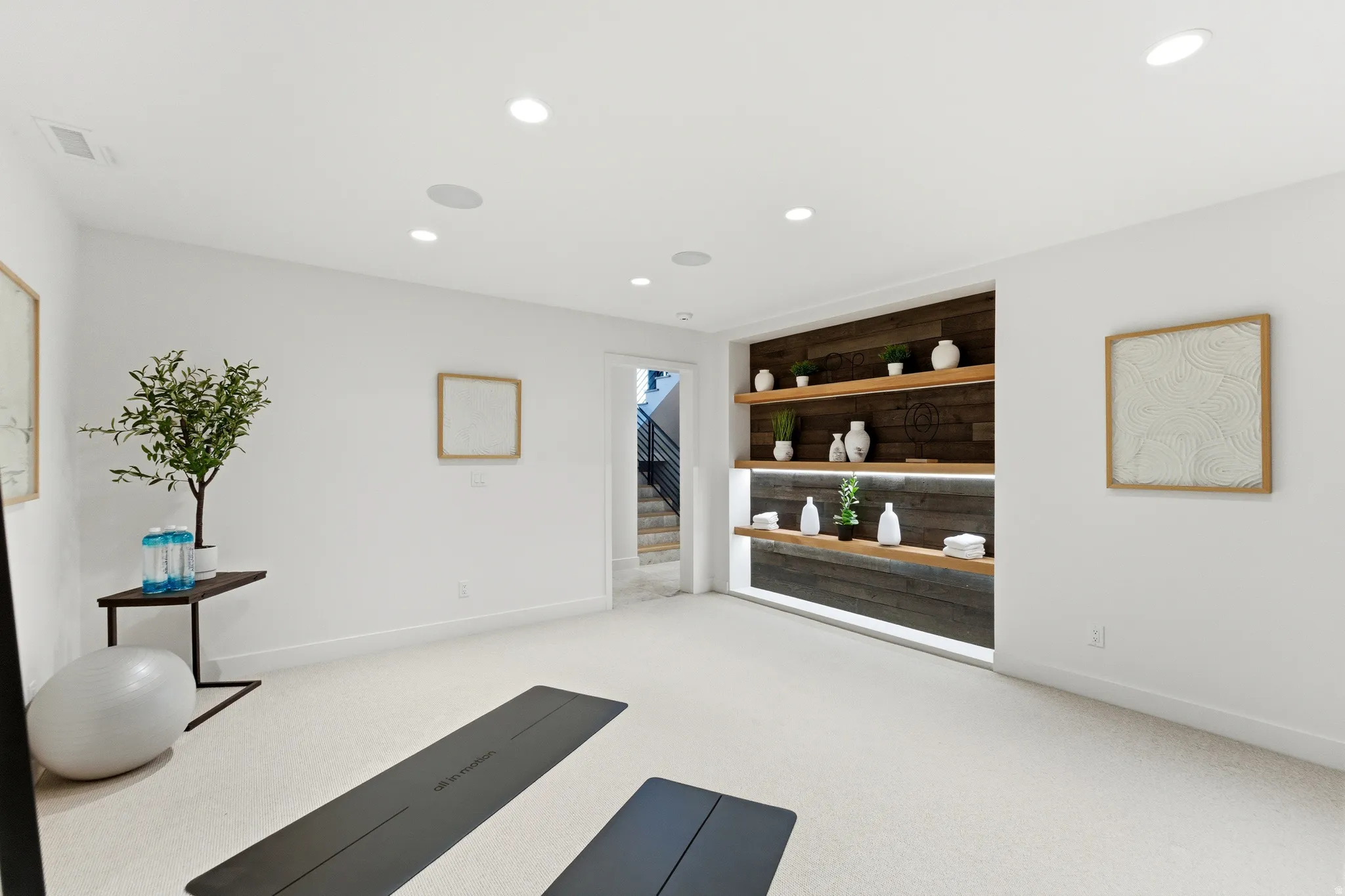 Exercise room with recessed lighting and light colored carpet