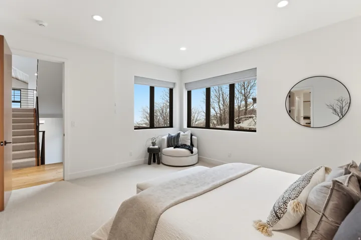 Bedroom featuring light colored carpet and recessed lighting