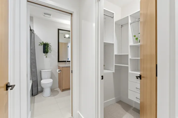 Bathroom featuring vanity, shower / tub combo, and light tile patterned floors