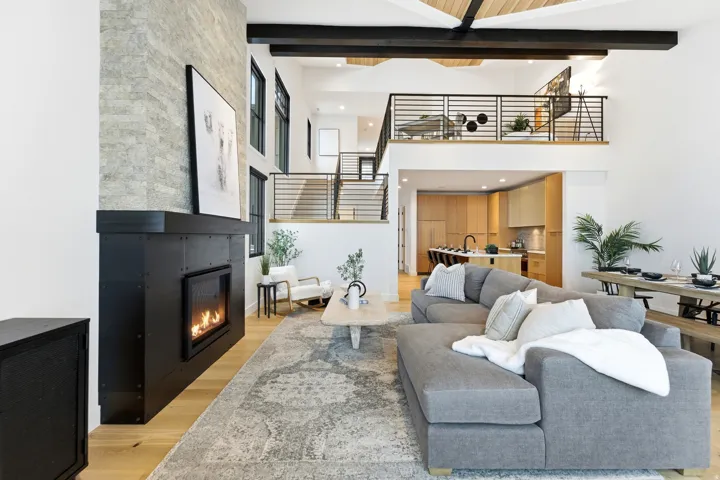 Living room with light wood-style flooring, a fireplace, and recessed lighting
