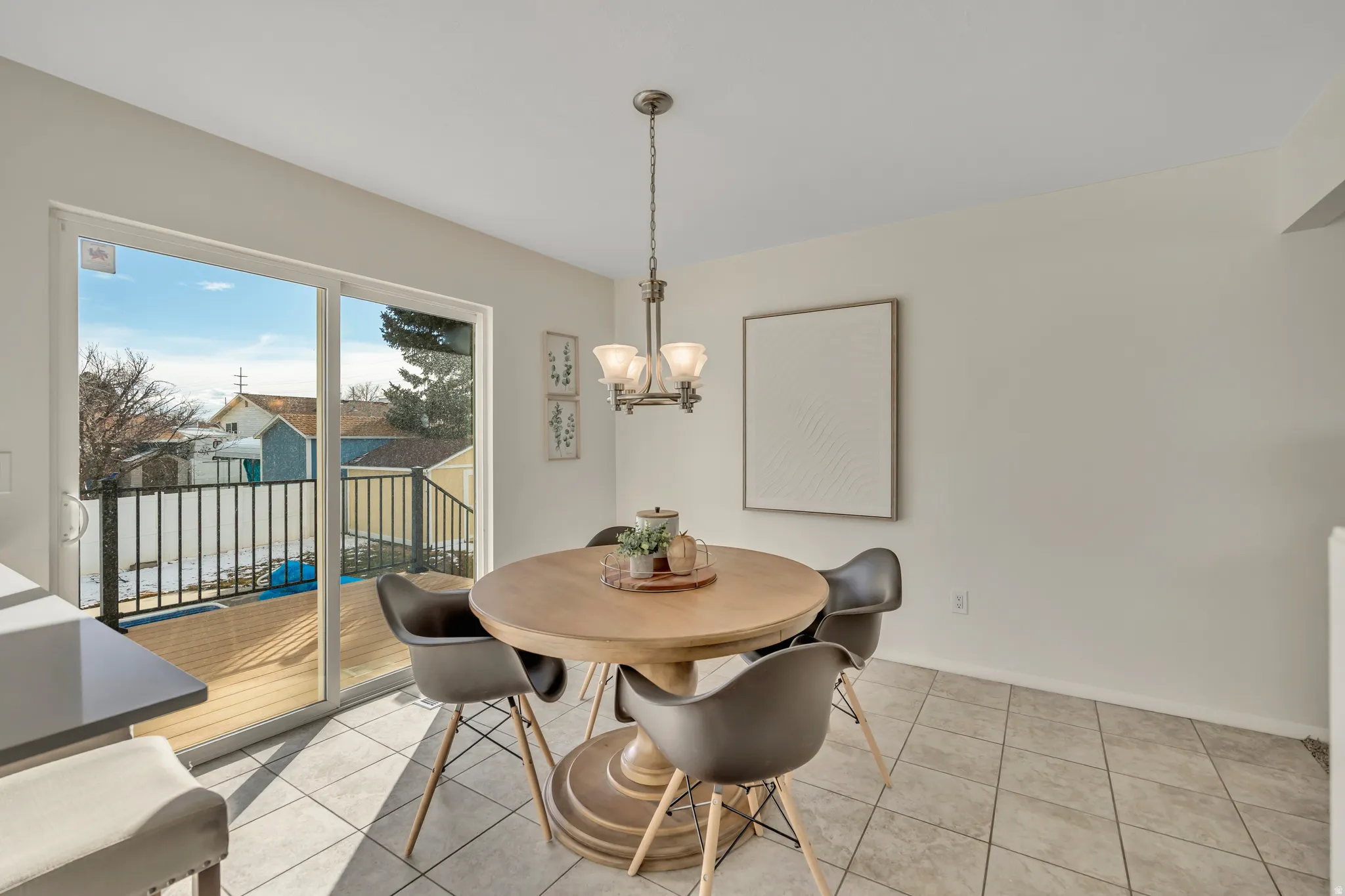 Dining room with suspended lighting and light tile patterned floors