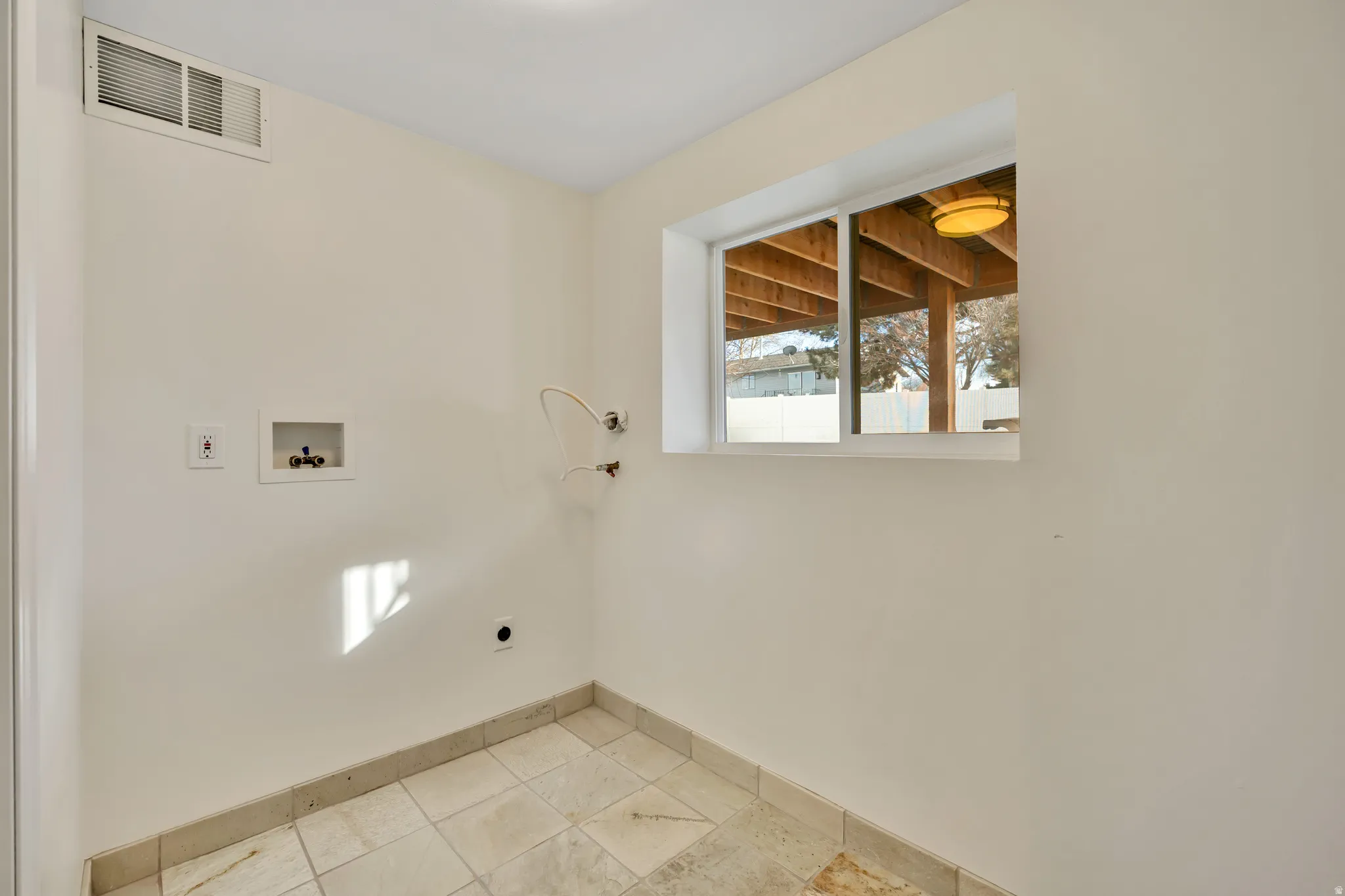 Laundry area with washer hookup and hookup for an electric dryer