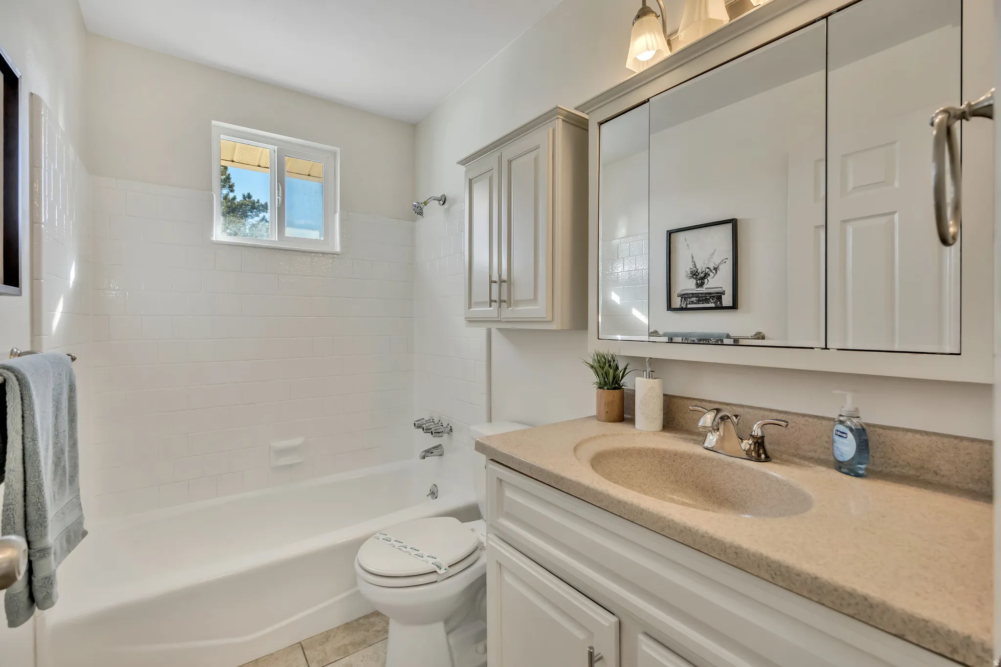 Bathroom featuring vanity and shower / washtub combination