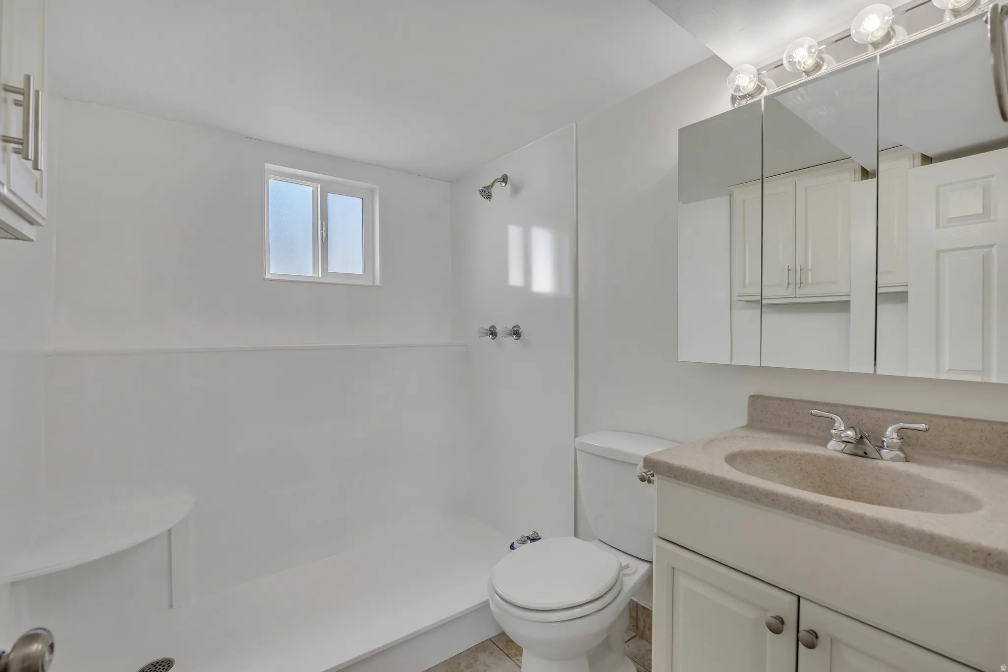 Bathroom featuring vanity and a stall shower