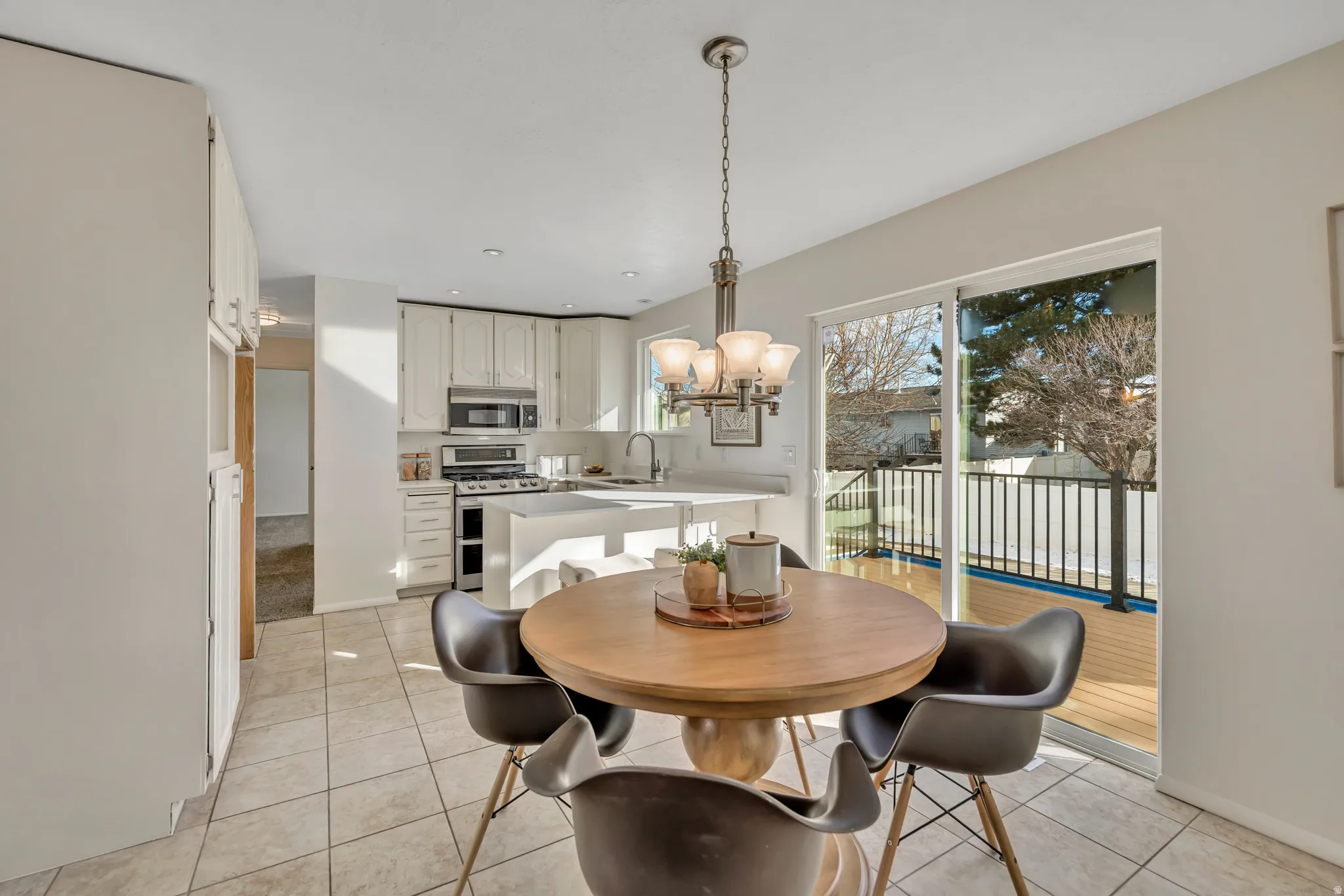 Dining area featuring a chandelier and light tile patterned flooring
