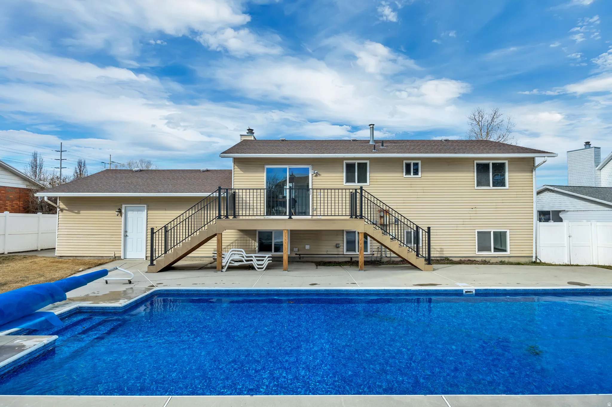 Rear view of property featuring a patio, a deck, and a chimney