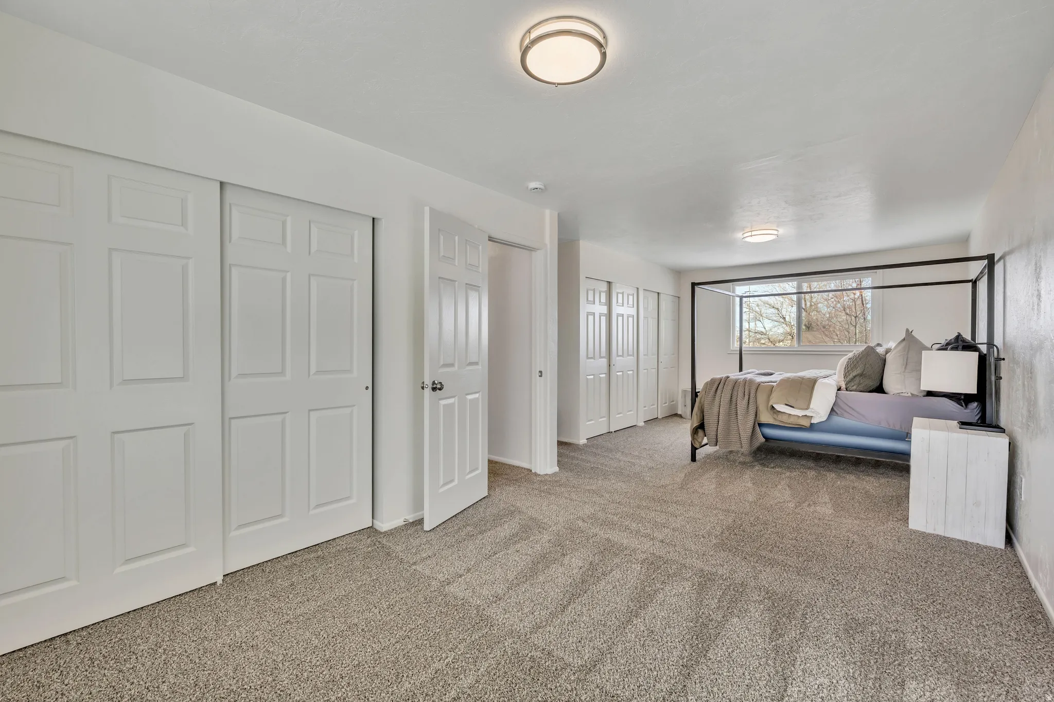 Bedroom with two closets and light carpet