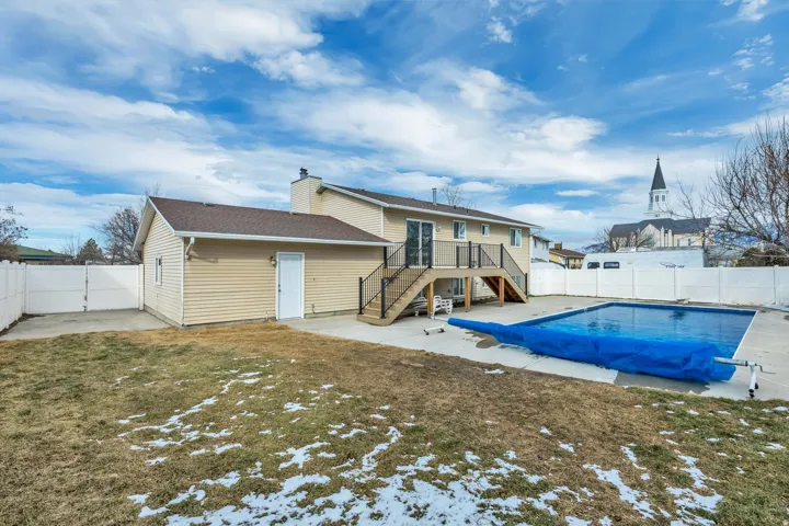 Rear view of house with a patio and a fenced backyard