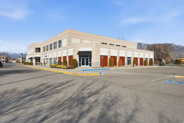 View of commercial property featuring uncovered parking