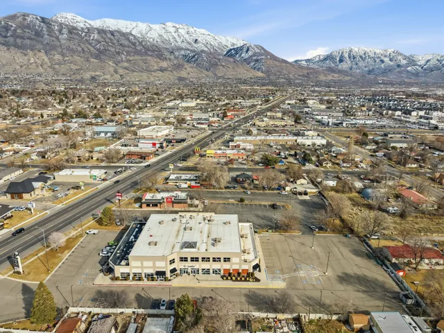 Aerial overview of property's location featuring a mountainous background