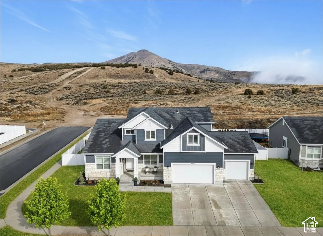 Corner lot home with mountain views, three-car garage, covered front porch, and easy access to Saratoga Springs, parks, and The Ranches Golf Course.