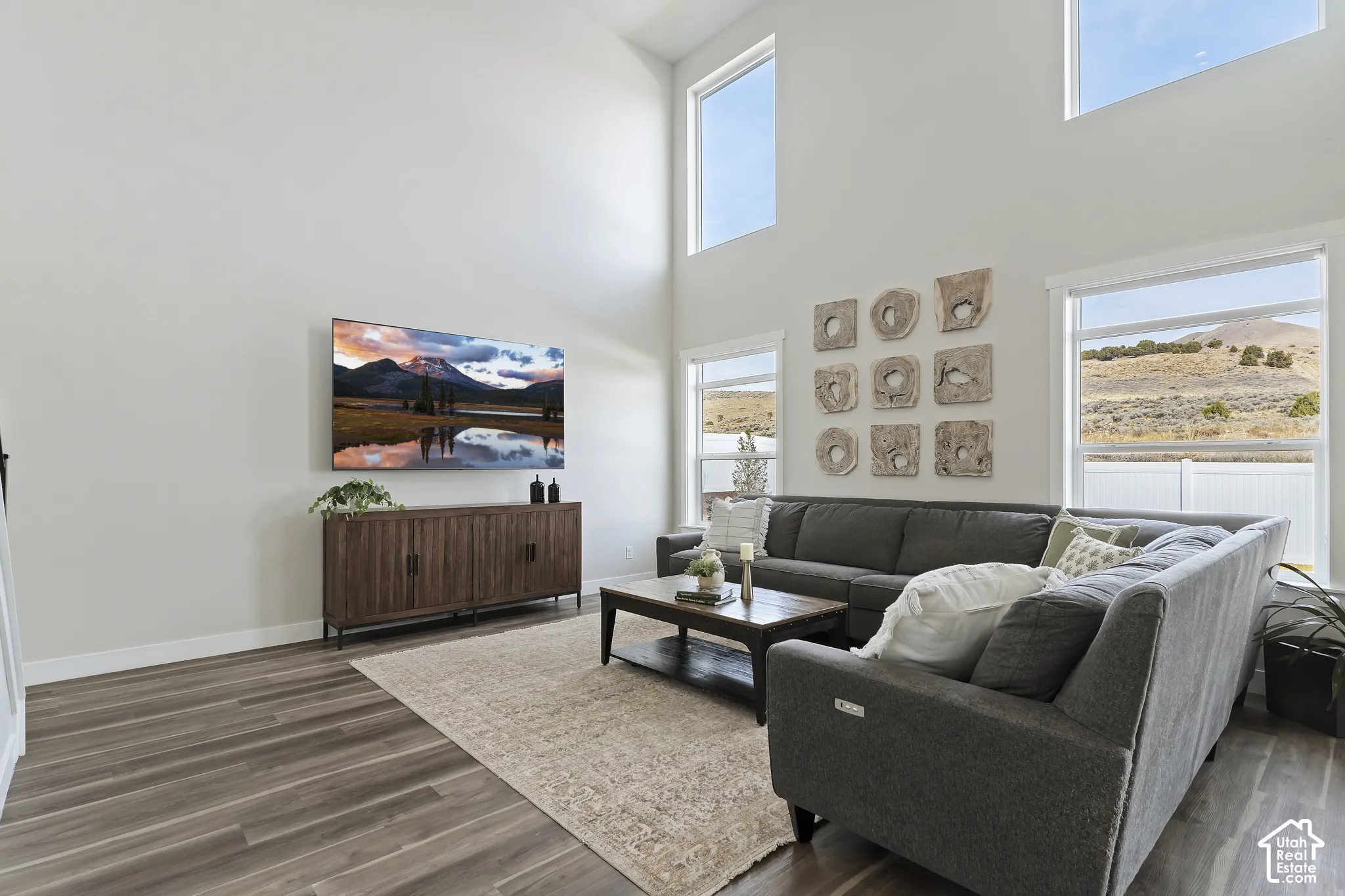 Open-concept living room filled with natural light and highlighted by dramatic ceiling height.