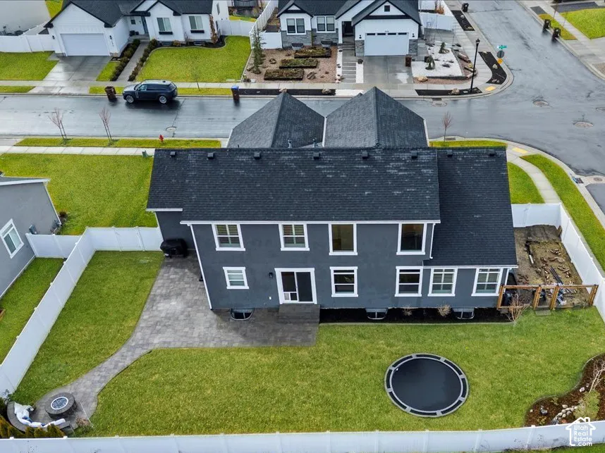 Fully fenced backyard with flat lawn, extended paver patio, and plenty of space for entertaining or play.