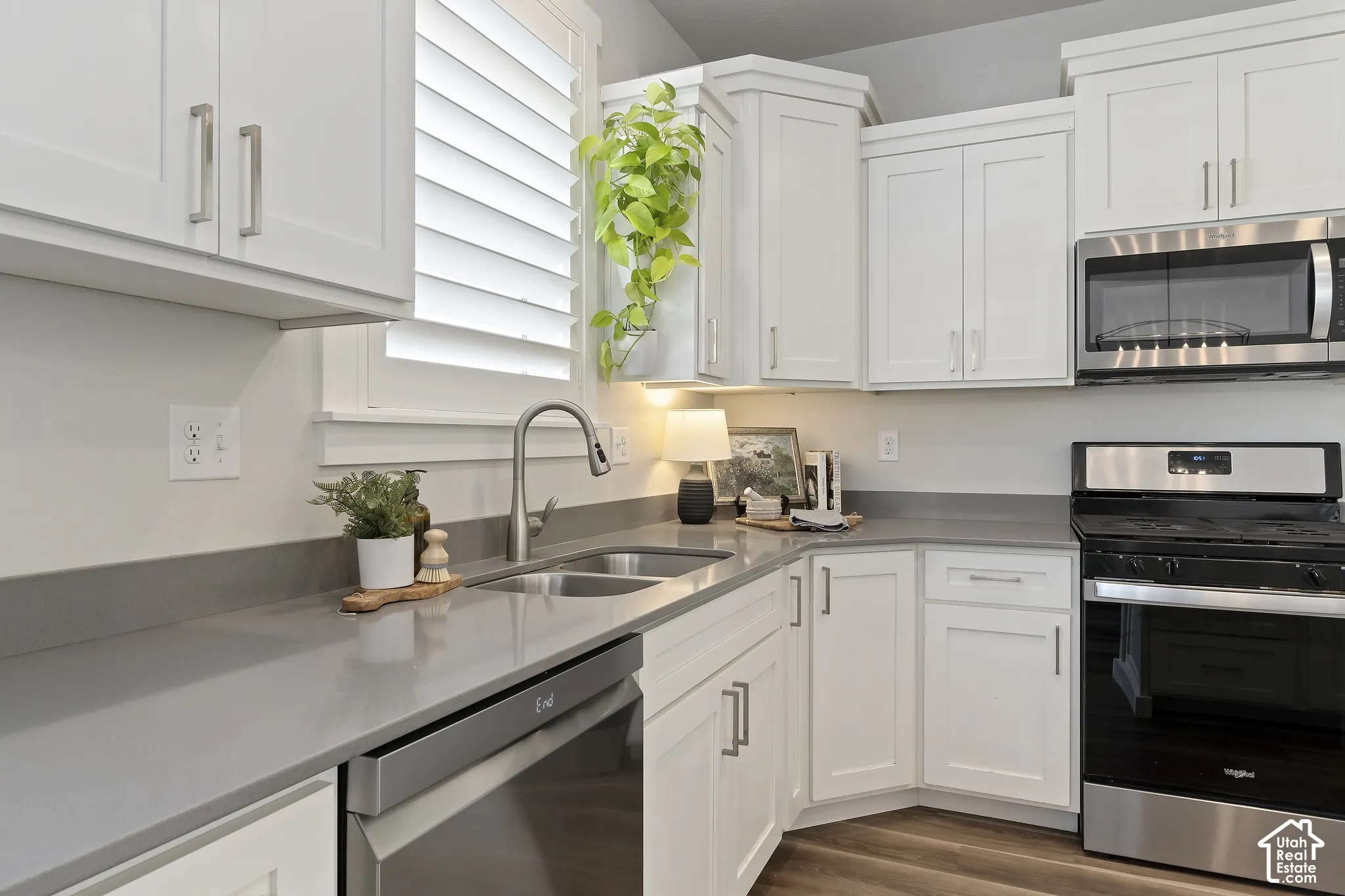 Spacious kitchen with oversized island, white cabinetry, granite countertops, and recessed lighting.