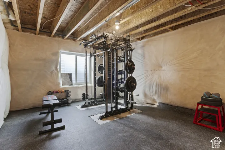 Unfinished basement currently configured as a home gym, offering room to expand and build equity.