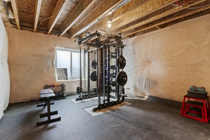 Unfinished basement currently configured as a home gym, offering room to expand and build equity.