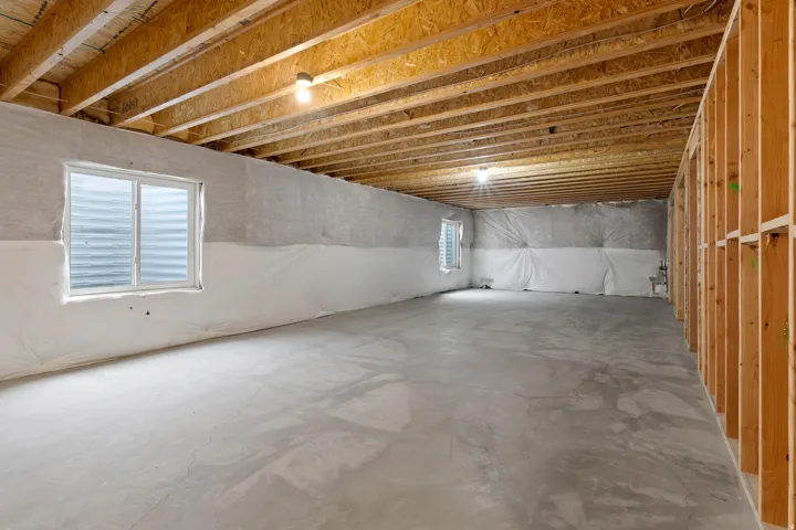 Expansive unfinished basement ready for future bedrooms, a theater, gym, or additional living space.