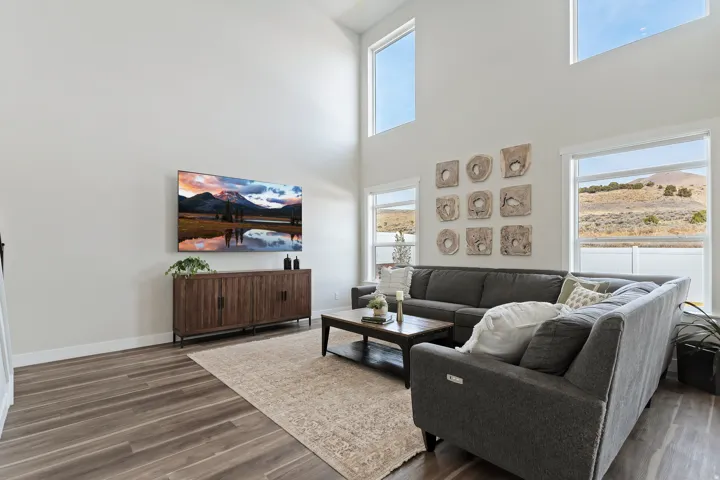 Open-concept living room filled with natural light and highlighted by dramatic ceiling height.
