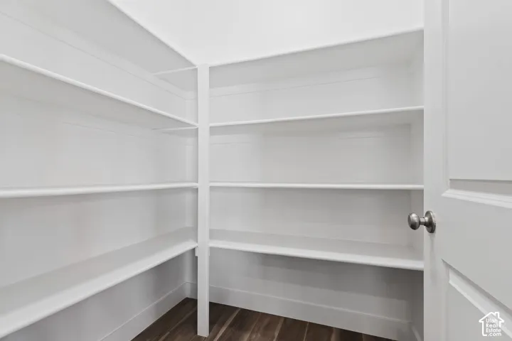 Walk-in pantry with extensive shelving and storage to keep the kitchen organized.