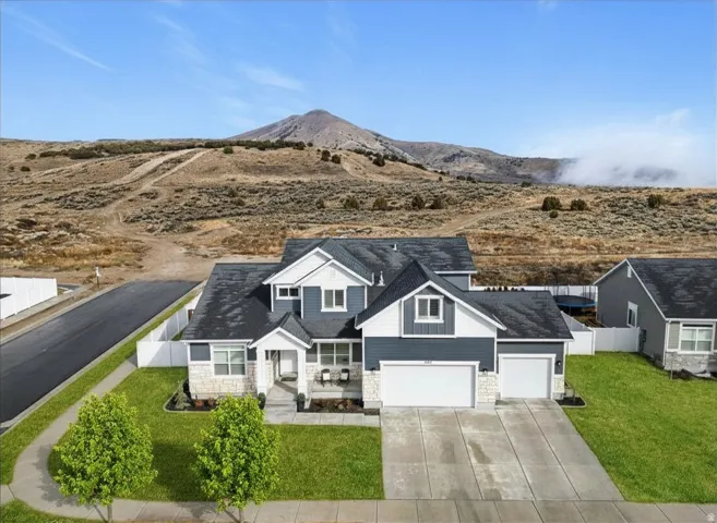 Corner lot home with mountain views, three-car garage, covered front porch, and easy access to Saratoga Springs, parks, and The Ranches Golf Course.