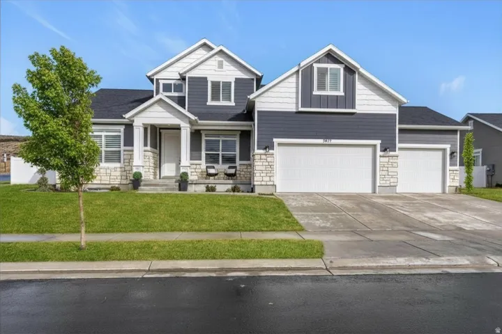 Front elevation showcasing the corner lot, three-car garage, and attractive curb appeal.