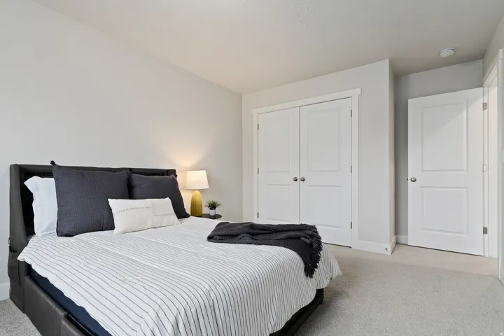 Secondary bedroom featuring generous closet space and flexible use for guests or family.