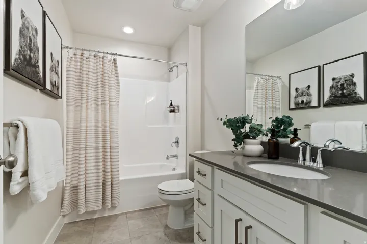 Great room showcasing soaring two-story ceilings, expansive windows, and an open floor plan designed for gathering.