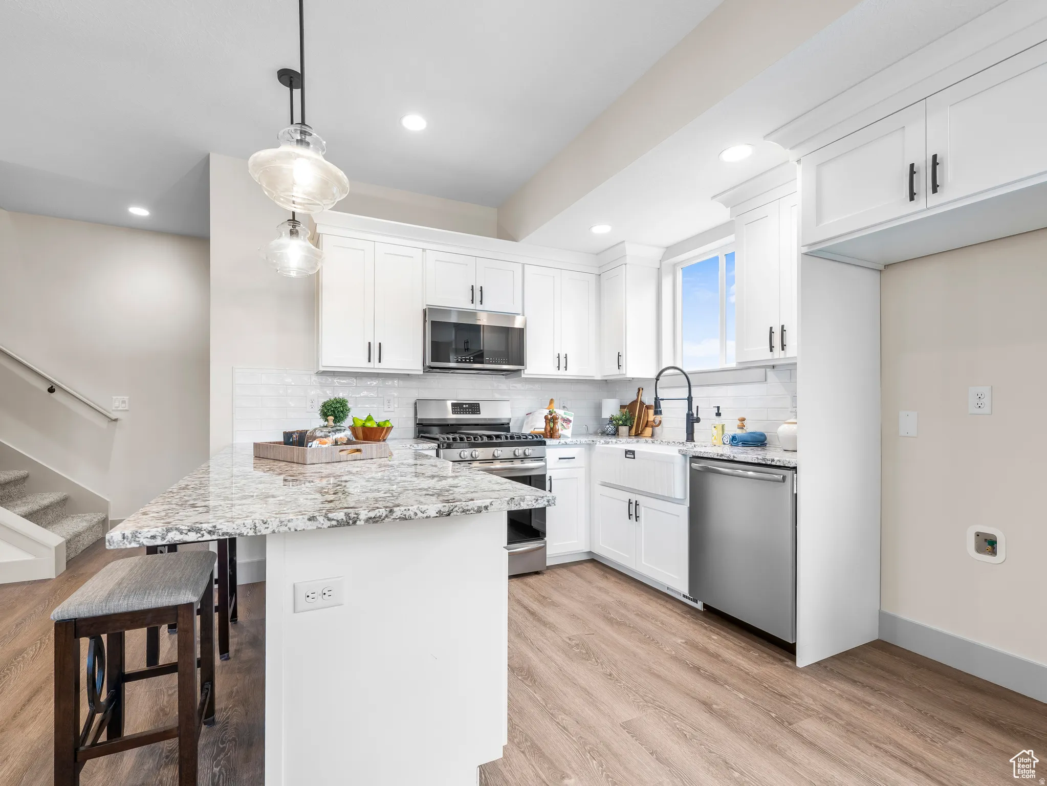 Upgraded cabinets, crown molding, tile backsplash, farmhouse sink, gas range, soft close drawers and cabinets