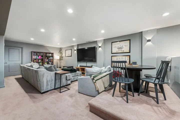 Living room featuring recessed lighting, carpet flooring, and a fireplace