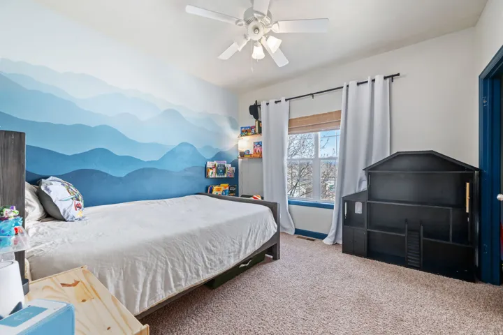 Bedroom with carpet flooring and a ceiling fan