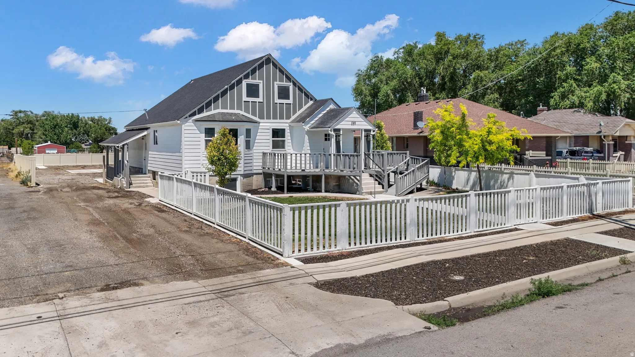 View of front of home featuring a fenced front yard and board and batten siding