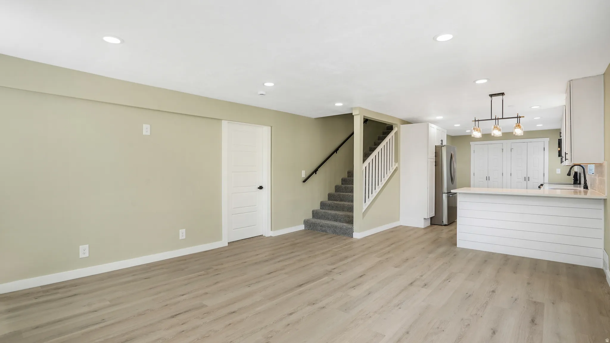 Unfurnished living room featuring recessed lighting and light wood-style floors
