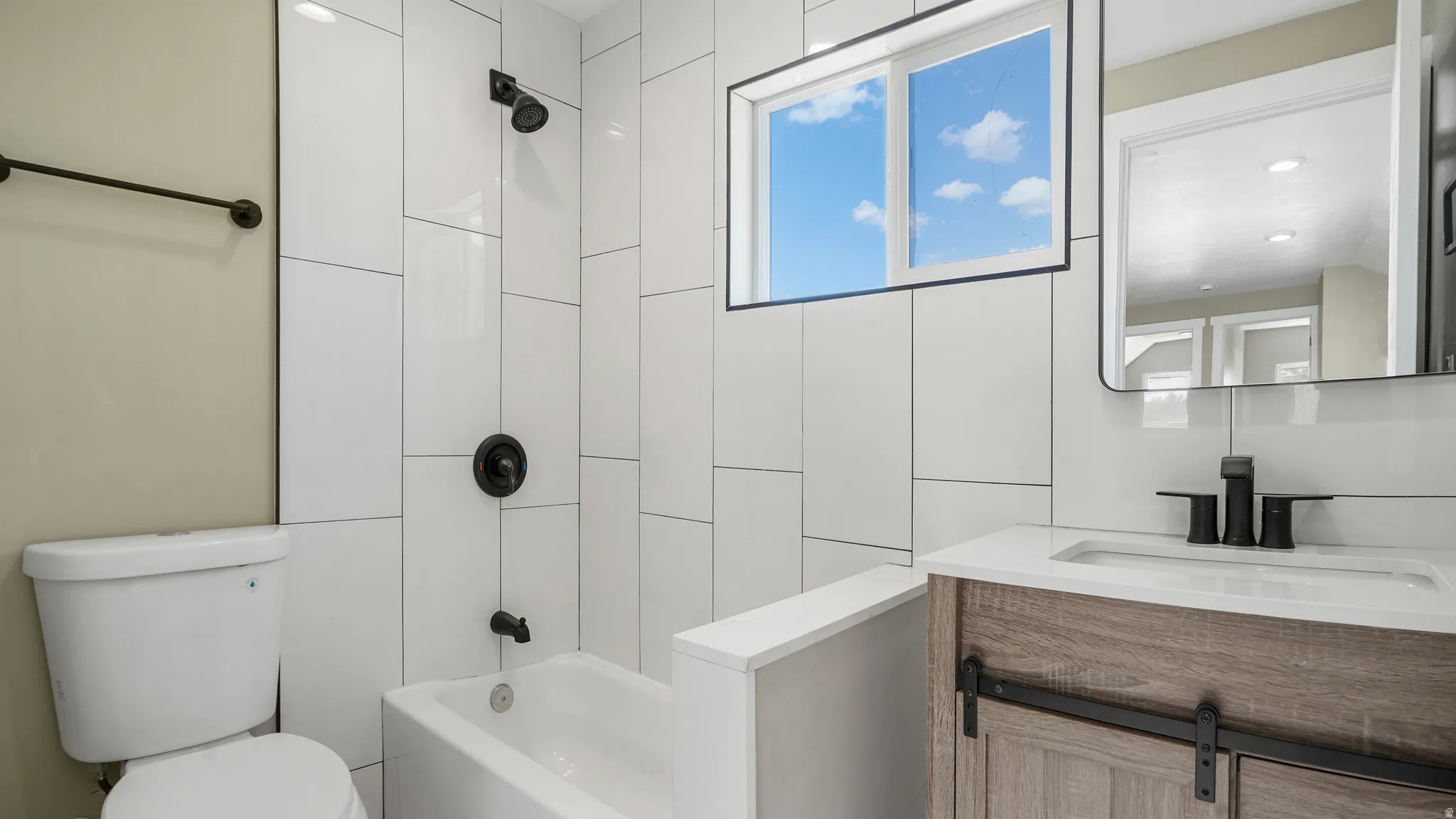 Full bath featuring vanity and bathing tub / shower combination