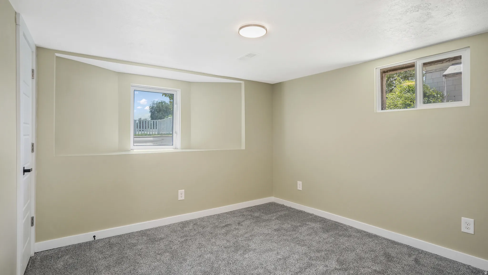 Unfurnished room with baseboards and carpet flooring