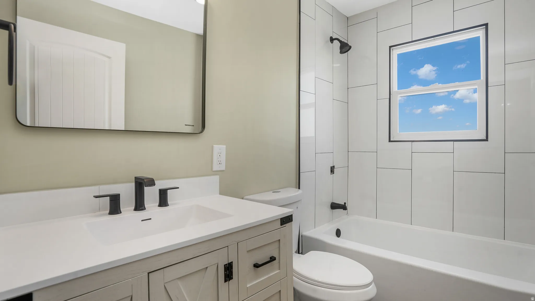 Bathroom with vanity and shower / tub combination