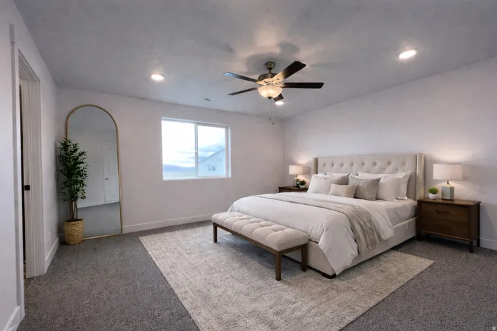 Primary bedroom featuring carpet floors, a ceiling fan, and recessed lighting