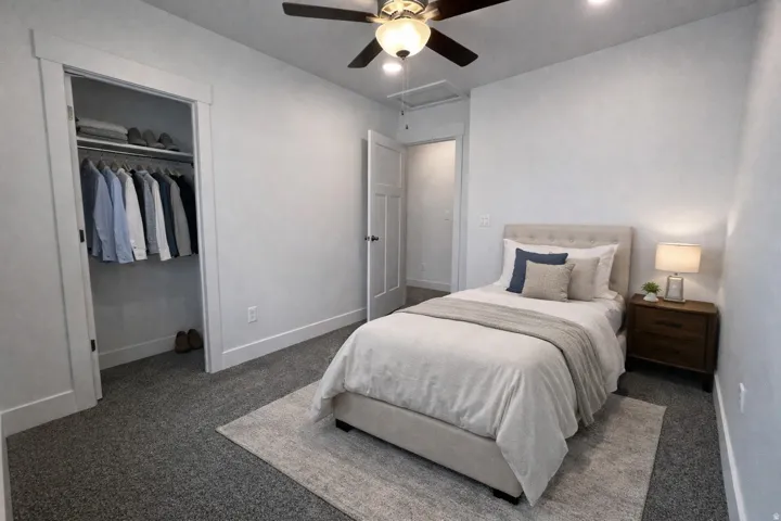Bedroom with carpet flooring, a ceiling fan, and a closet