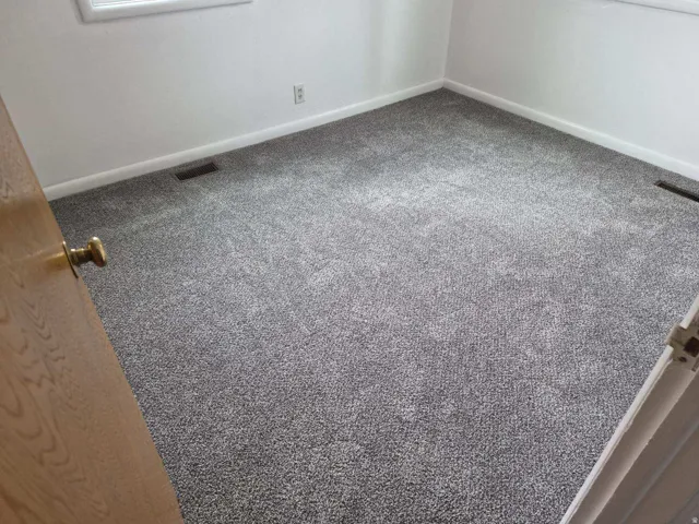 Unfurnished room featuring carpet flooring and baseboards