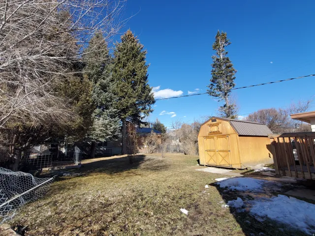 View of yard featuring a storage unit